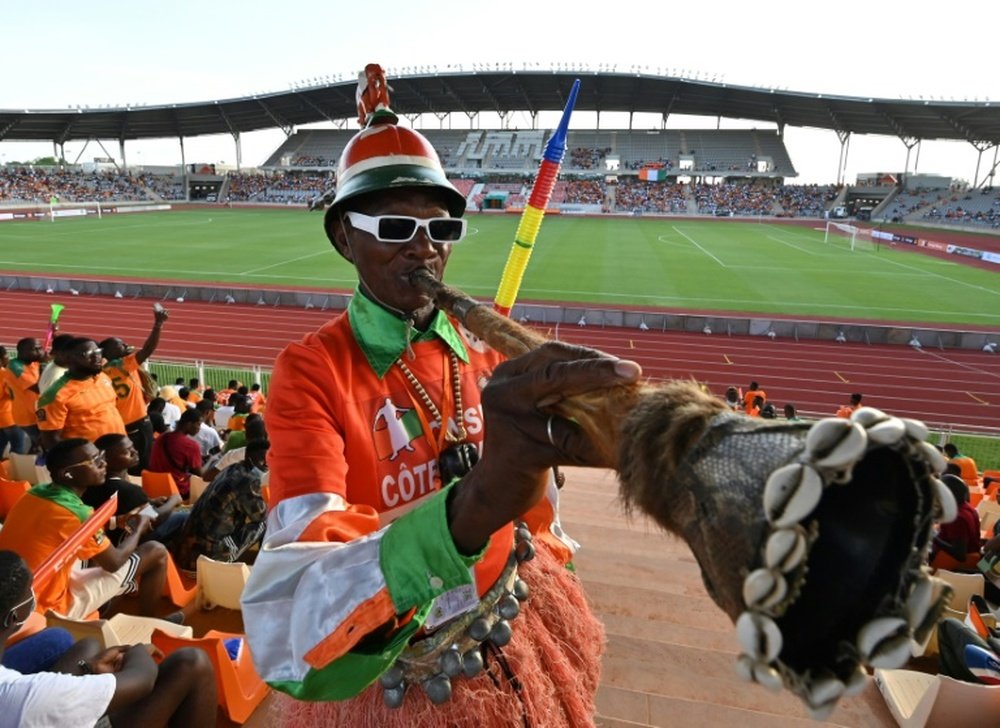 A fan blows a horn before the 2023 AFCON qualifier between the Ivory Coast and Zambia. AFP