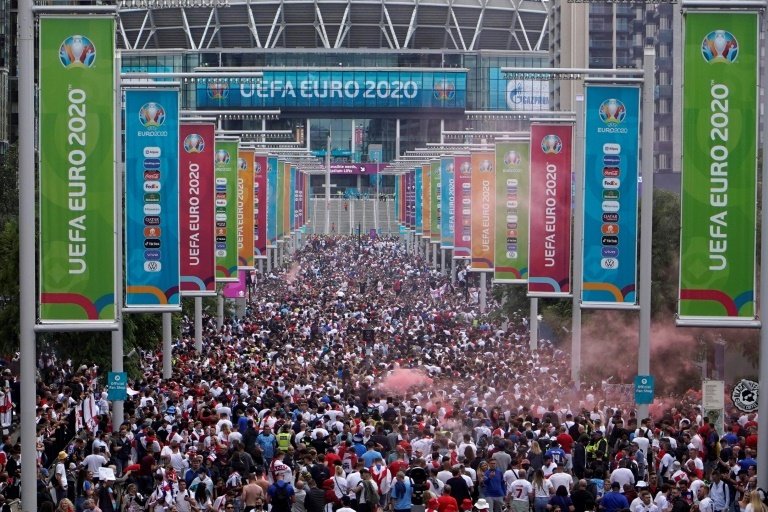 Fans gather at Wembley Stadium ahead of a Euro 2020 final football match. AFP