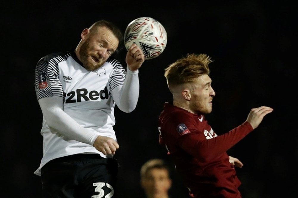 Wayne Rooney's (L) son was not allowed to head the ball in the USA. AFP