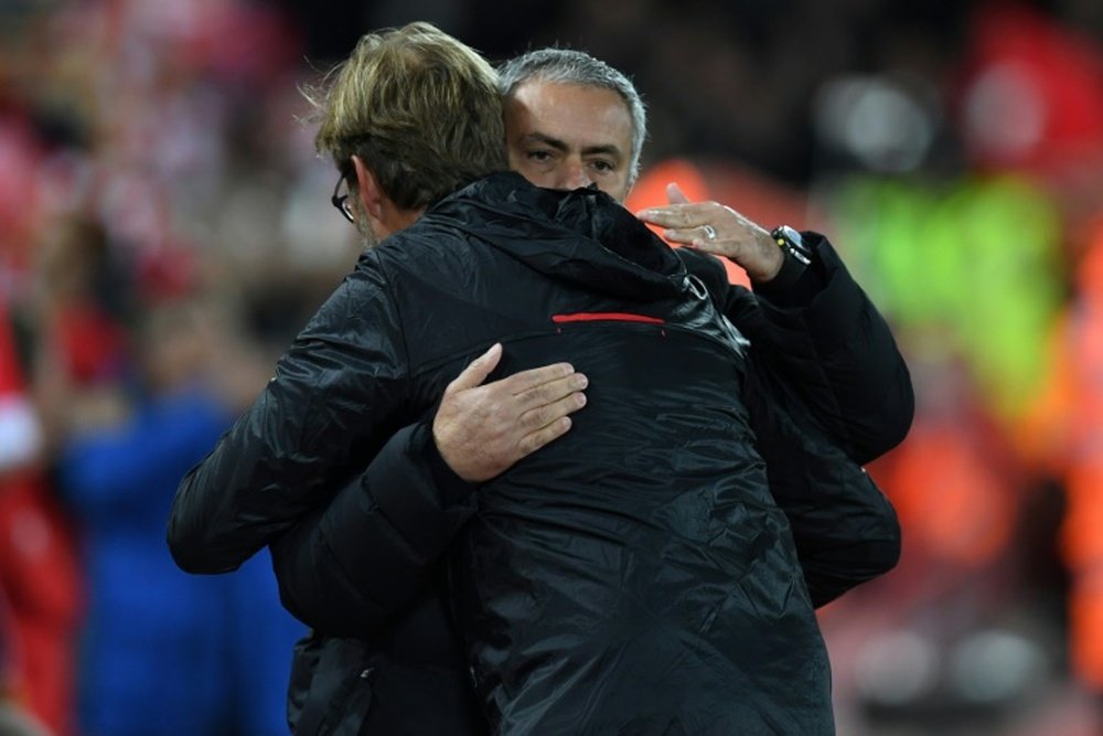 Liverpools manager Jurgen Klopp greets Manchester Uniteds manager Jose Mourinho (R) ahead of the English Premier League football match October 17, 2016