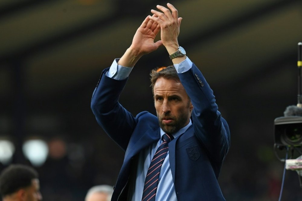 Englands manager Gareth Southgate applauds supporters