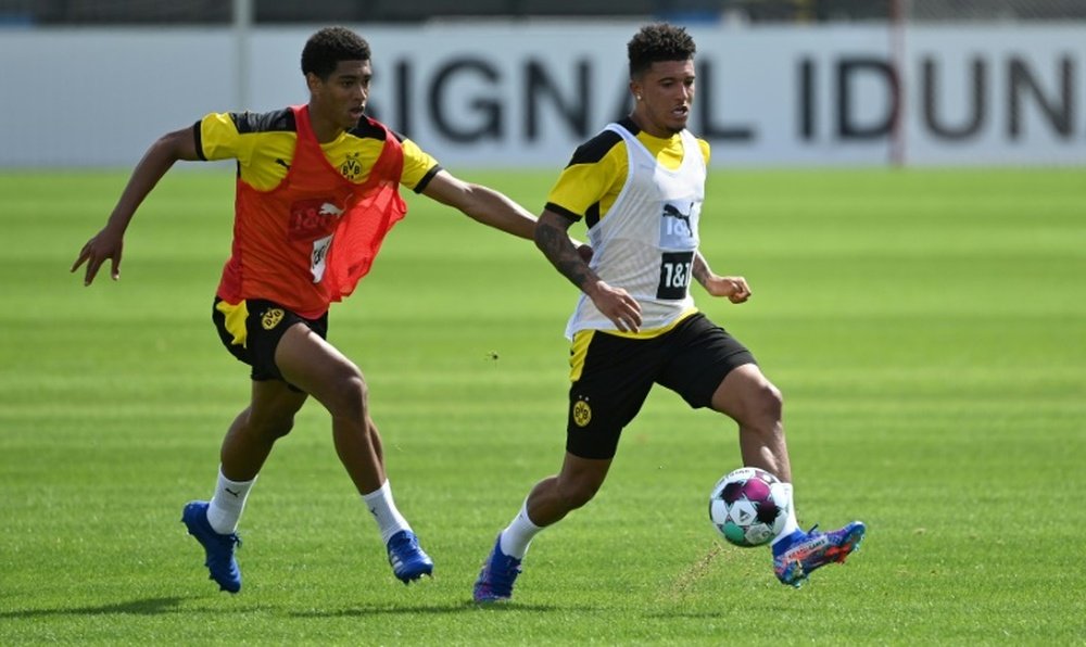 Sancho (R) has flown to Dortmund amid rumours over a move to Man Utd. AFP