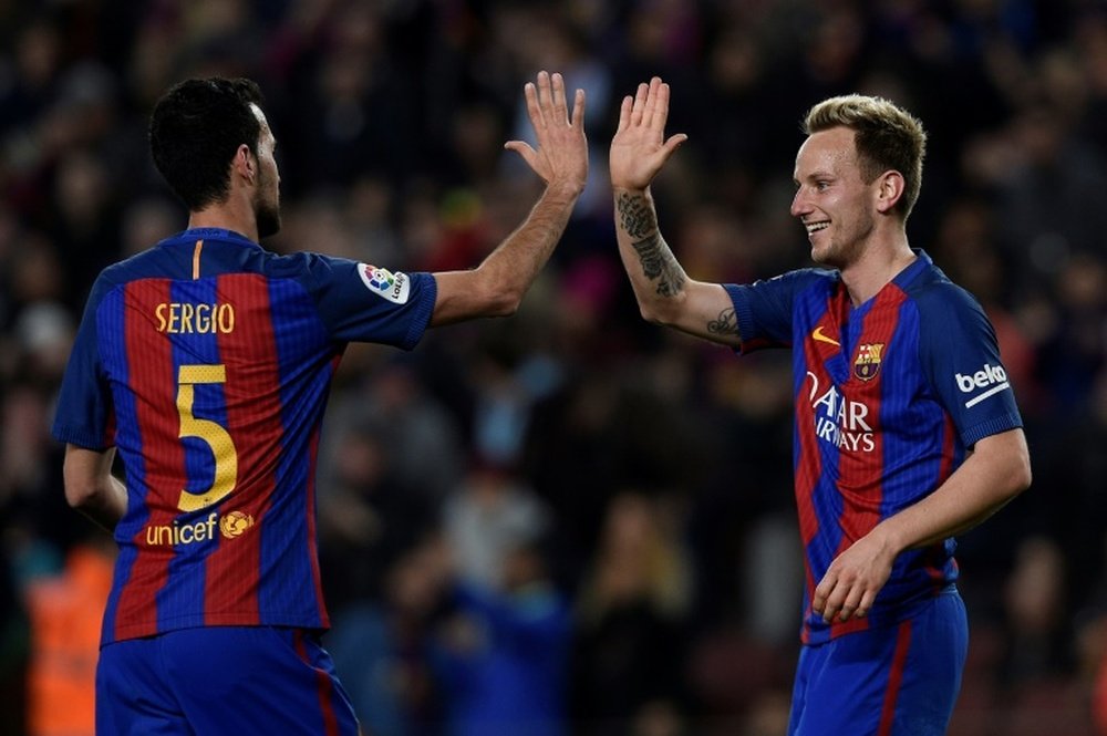 Ivan Rakitic has extended his deal with Barca. AFP