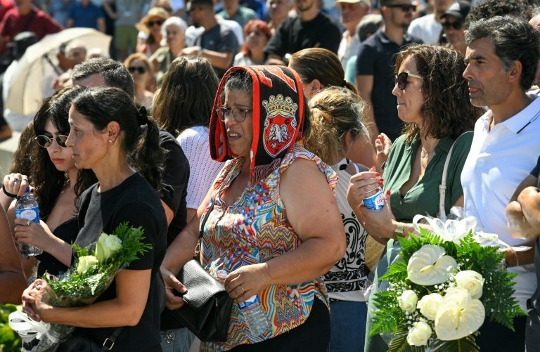 People wait outside the funeral chapel for the public wake of Diogo Jota and his brother. AFP