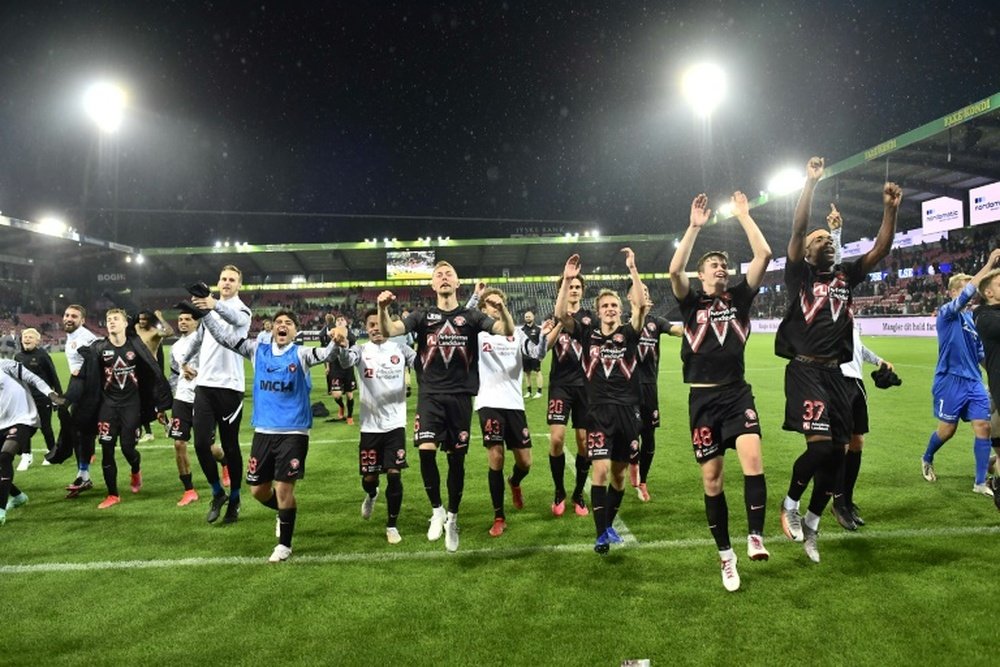 Danish delight: Midtjyllands players celebrate after defeating Celtic. AFP