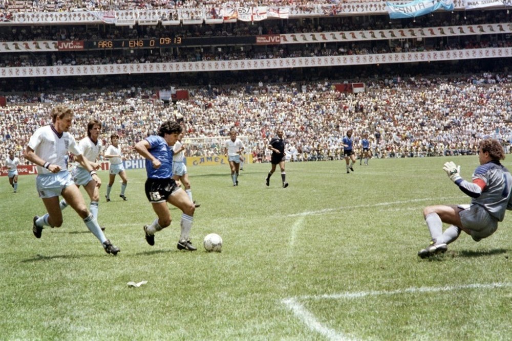 Diego Maradona runs past England defender Terry Butcher. AFP