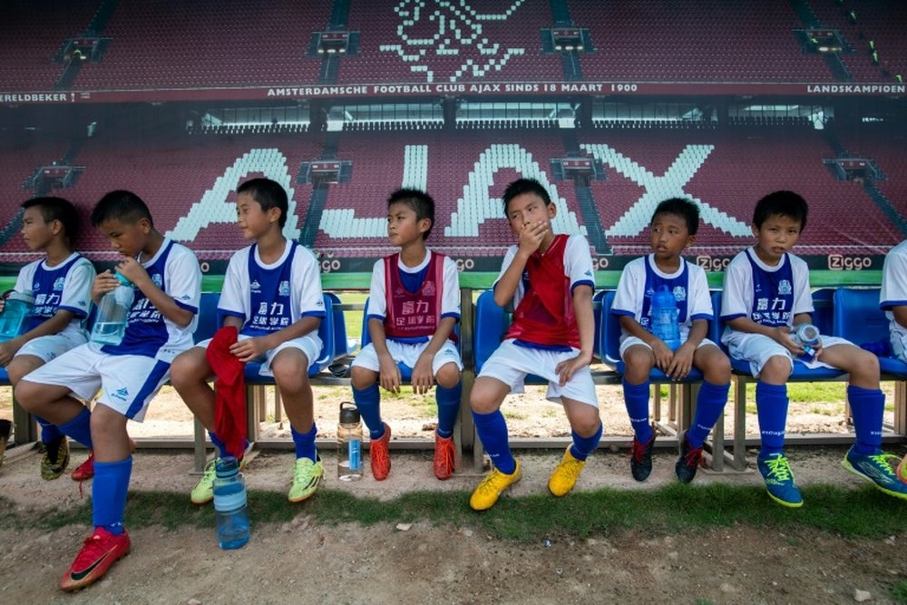 Children rest after a training session at the Guangzhou R&F Football Academy in Meizhou. AFP