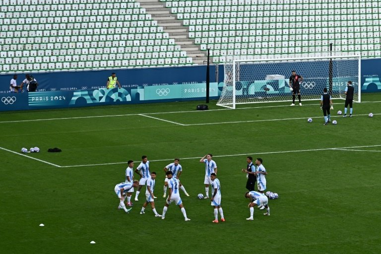 The Argentina players came back out to warm up in an empty stadium. AFP