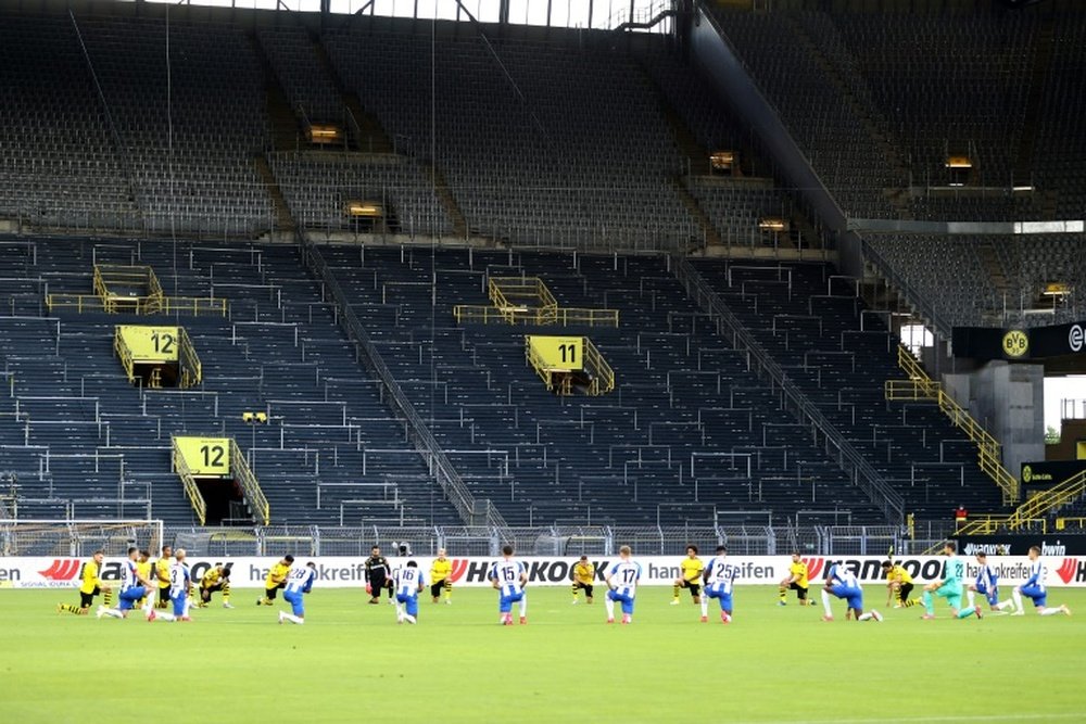 Borussia Dortmund and Hertha berlin players took a knee in solidarity. AFP
