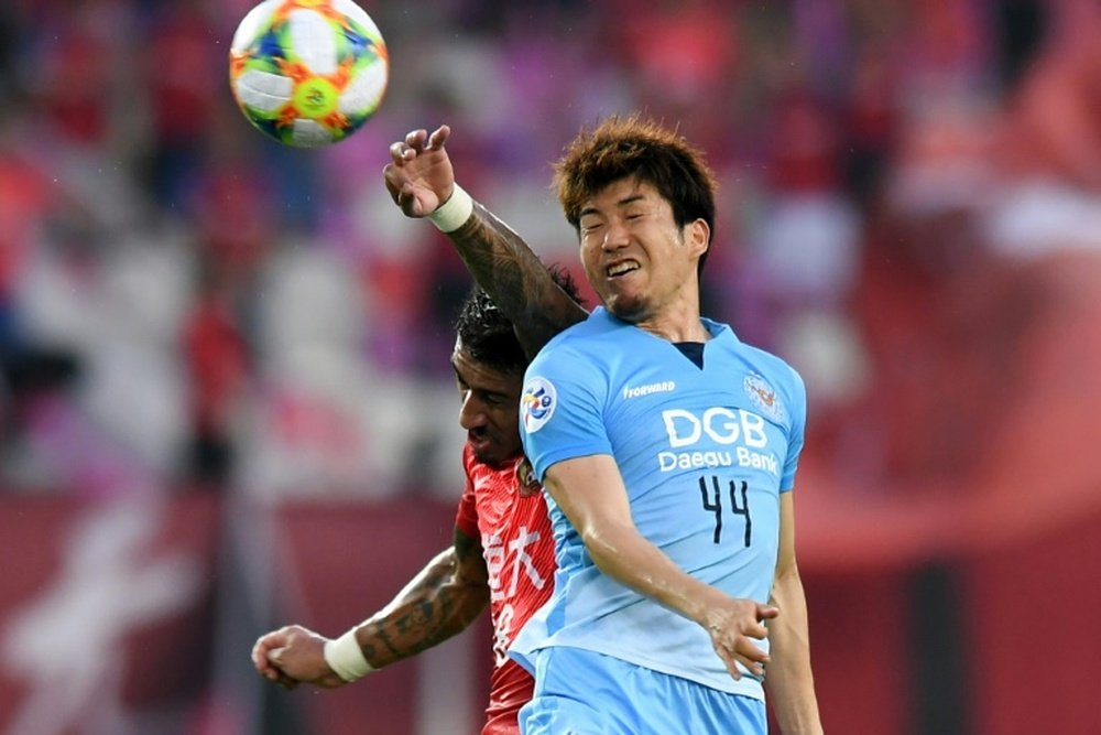Paulinho rises to beat Tsubasa. AFP
