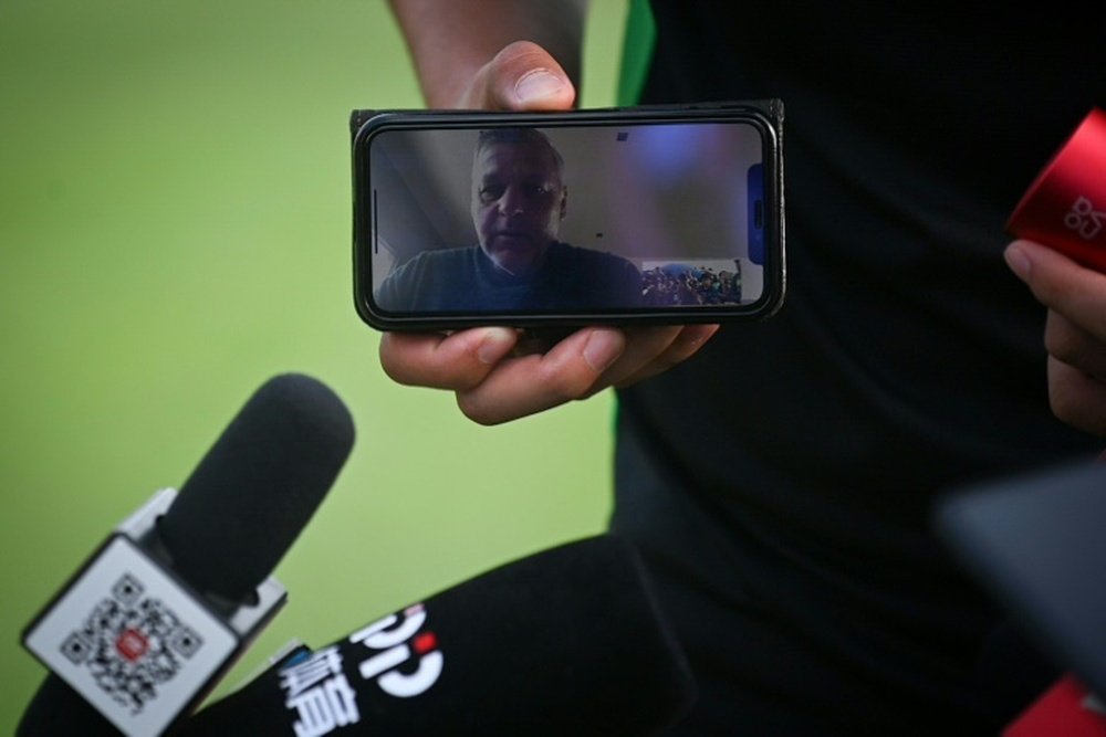 Beijing Guoan's coach is locked out of China and gave his press conference from France. AFP