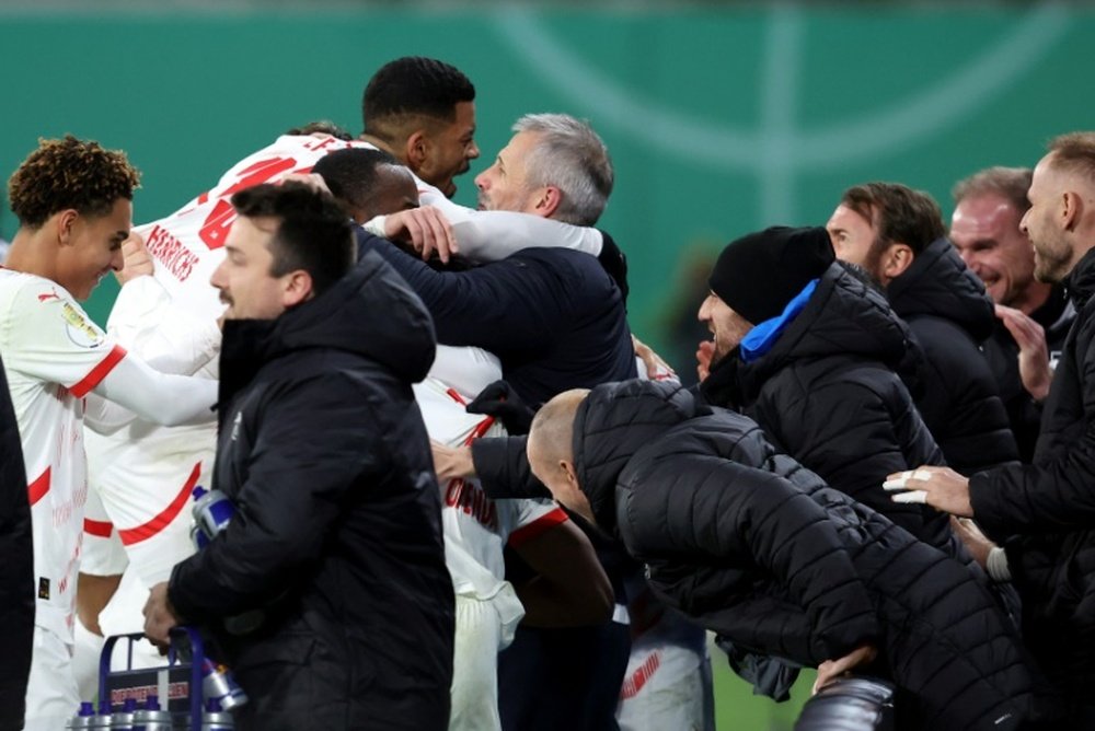 RB Leipzig coach Marco Rose was embraced by his players after Openda's second goal. AFP