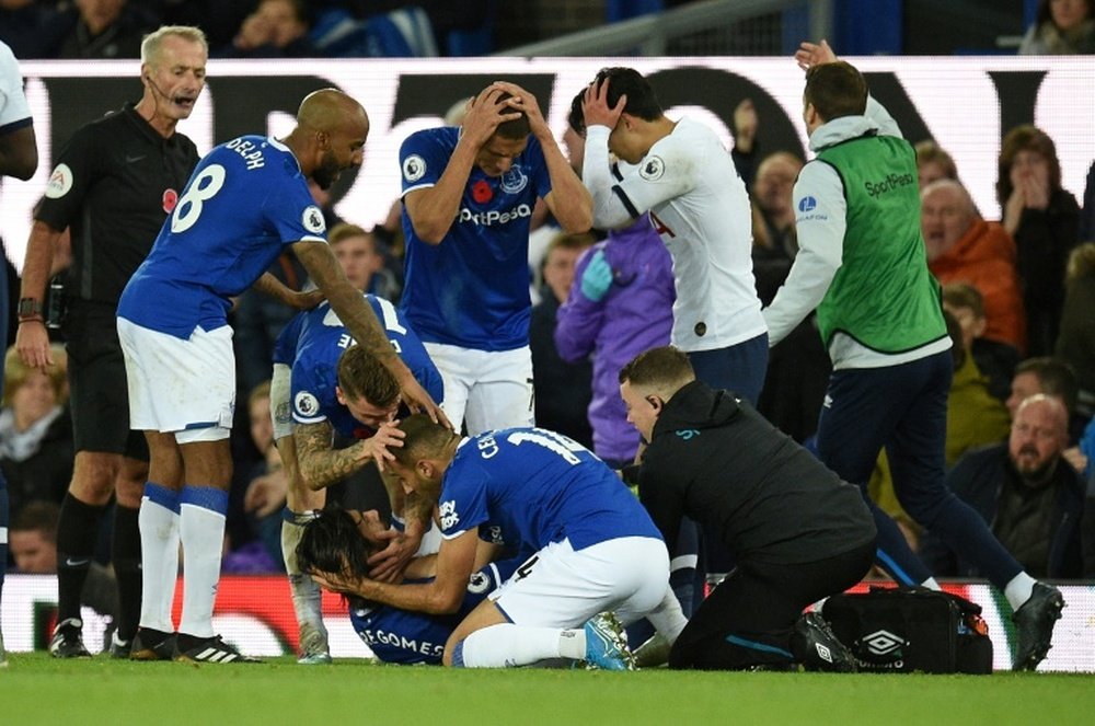 Everton players comfort teammate André Gomes. AFP