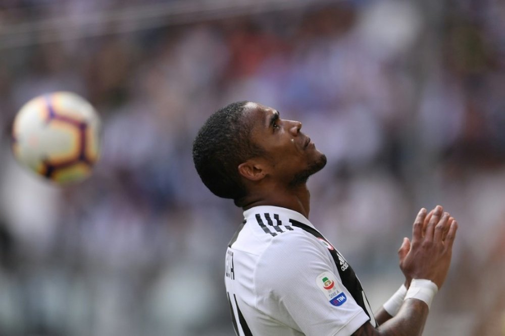 Winger Douglas Costa looks to the heavens after missing a goalscoring opportunity. AFP