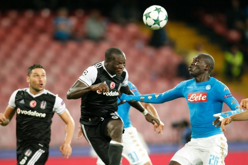 Besiktas forward Vincent Aboubakar (C) scores in front of Napoli defender Kalidou Koulibaly. AFP