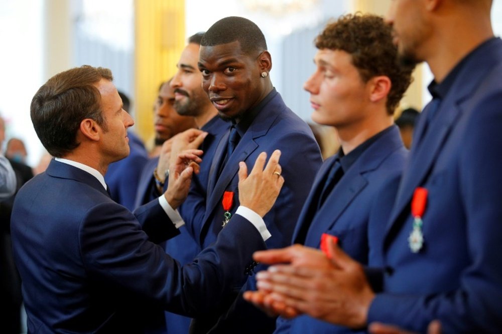 Emmanuel Macron presented Paul Pogba with the Legion of Honour order of merit in 2019. AFP