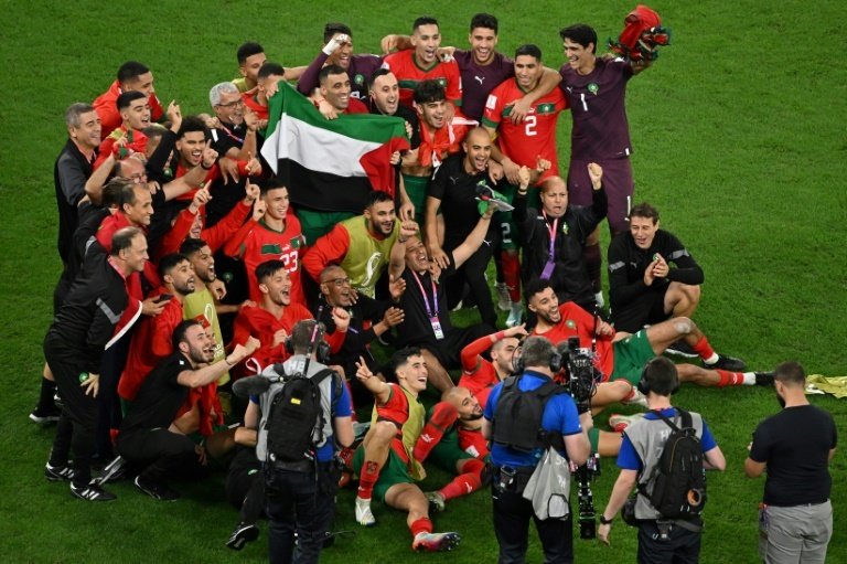 Moroccan players celebrate with Palestinian flag after beating Spain