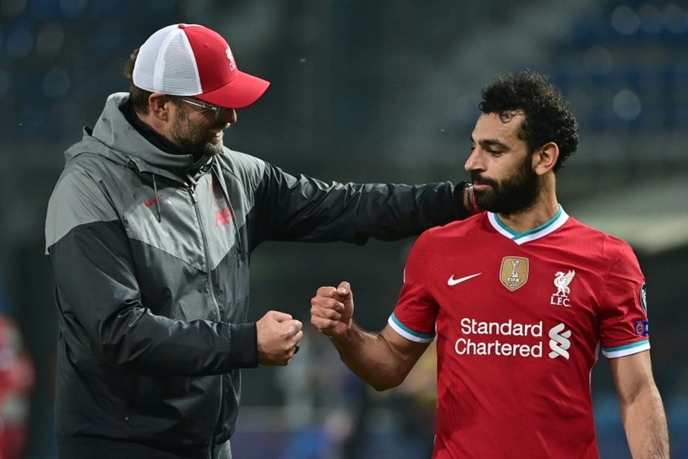 Liverpools Mohamed Salah (right)has tested positive for coronavirus. AFP