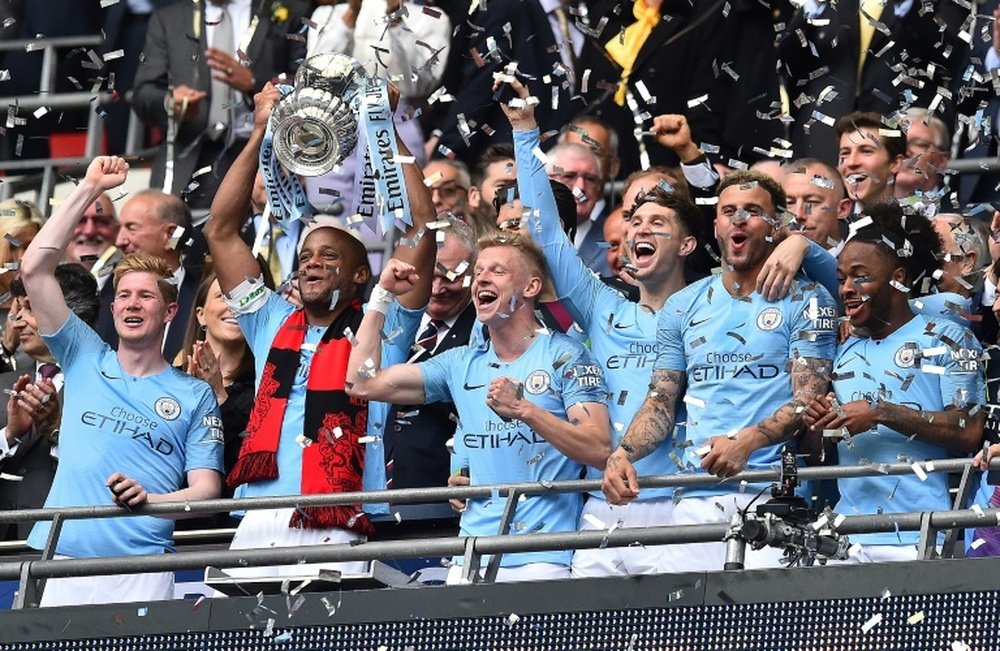 Vincent Kompany lifts the FA Cup after a comfortable 6-0 win over Watford. AFP