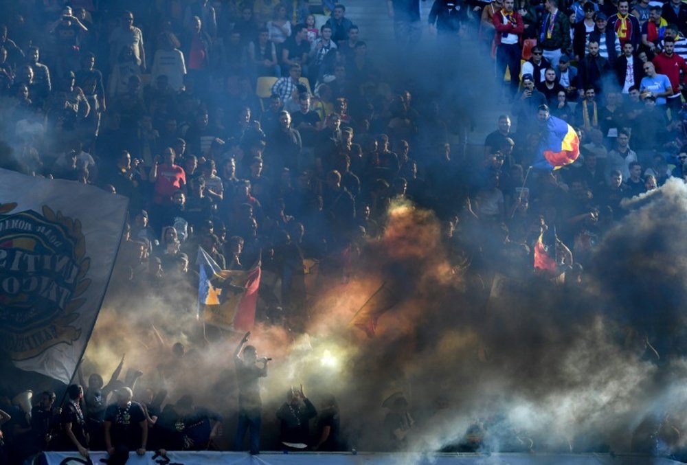 Romania were punished by UEFA for the behaviour of their supporters during a game v Serbia. AFP