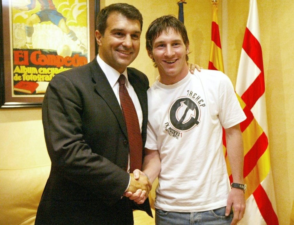 Joan Laporta shook hands with Lionel Messi in 2005. AFP