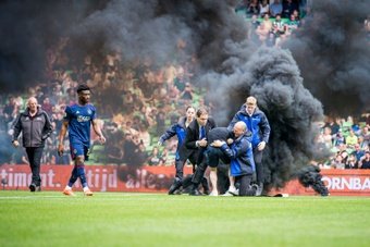 A Dutch league match between Groningen and Ajax was abandoned after just nine minutes on Sunday after fireworks and smoke bombs were thrown onto the pitch.