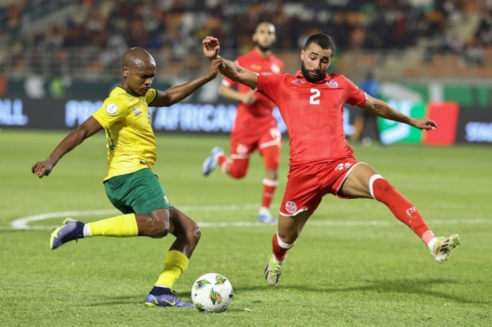 South Africa forward Percy Tau (L) crossed under pressure from Tunisia defender Ali Abdi. AFP
