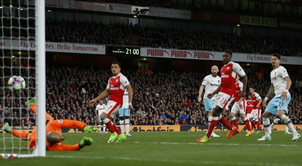 Arsenals midfielder Ozil (2nd R) watches as his shot beats West Ham Uniteds goalkeeper Randolph