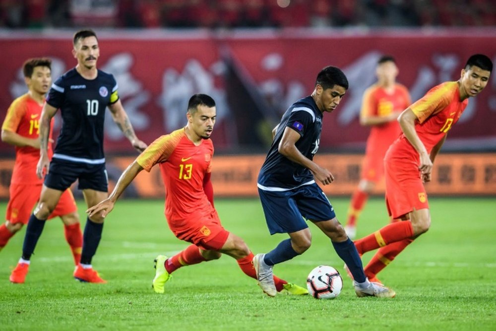 Guam (black) play China in Sunday's World Cup qualifiers. AFP