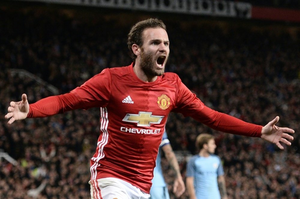 Juan Mata celebrates scoring in the EFL Cup against Manchester City. AFP