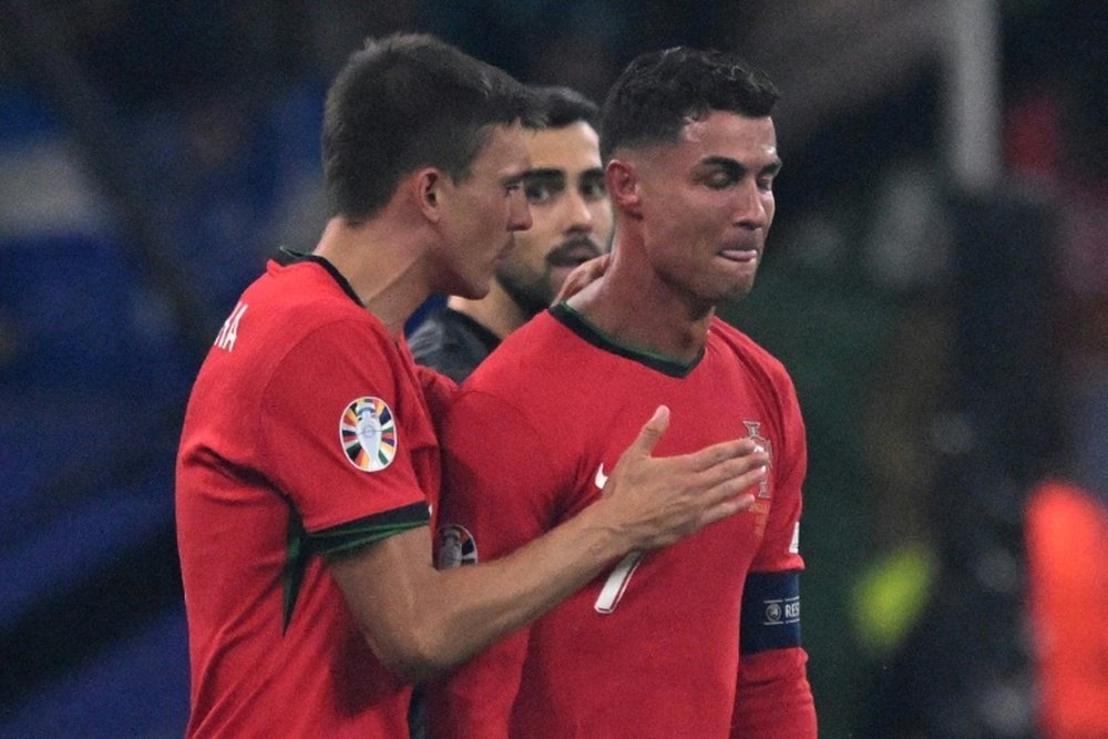 Cristiano Ronaldo reacts to his missed penalty kick against Slovenia. AFP
