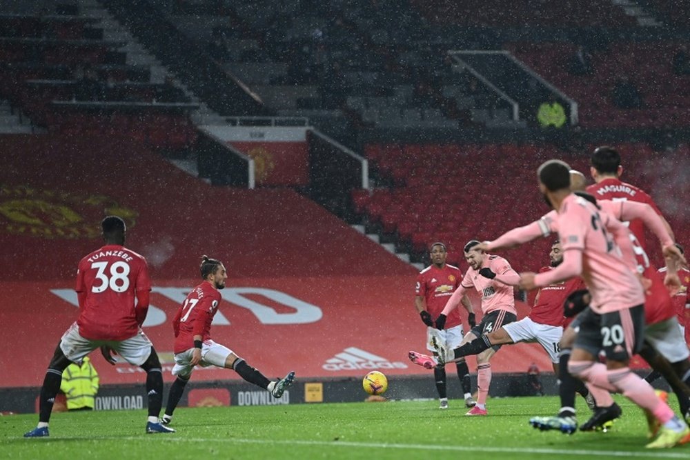 Oliver Burke (centre) scores for Sheffield United against Manchester United. AFP