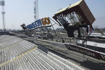 At least five people were injured at a Chile football stadium on Friday after an advertising structure collapsed under the weight of Colo Colo fans that had climbed on top.