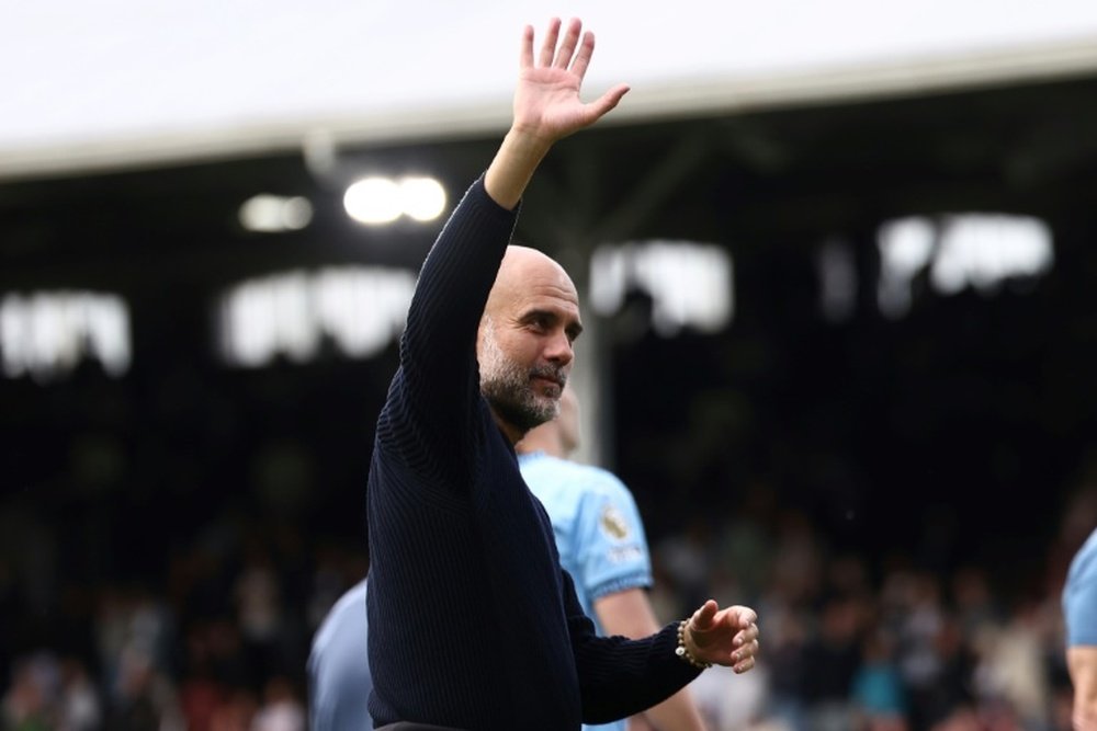 Guardiola waves to the crowd after his sides 2-0 win away to Fulham. AFP