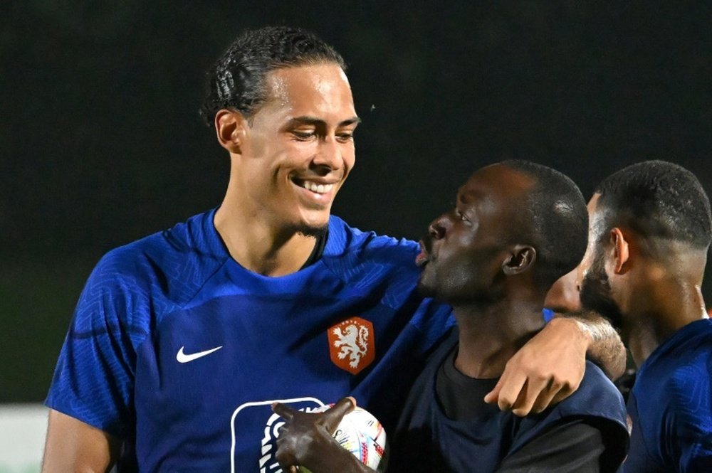 Virgil van Dijk met migrant workers in Qatar. AFP