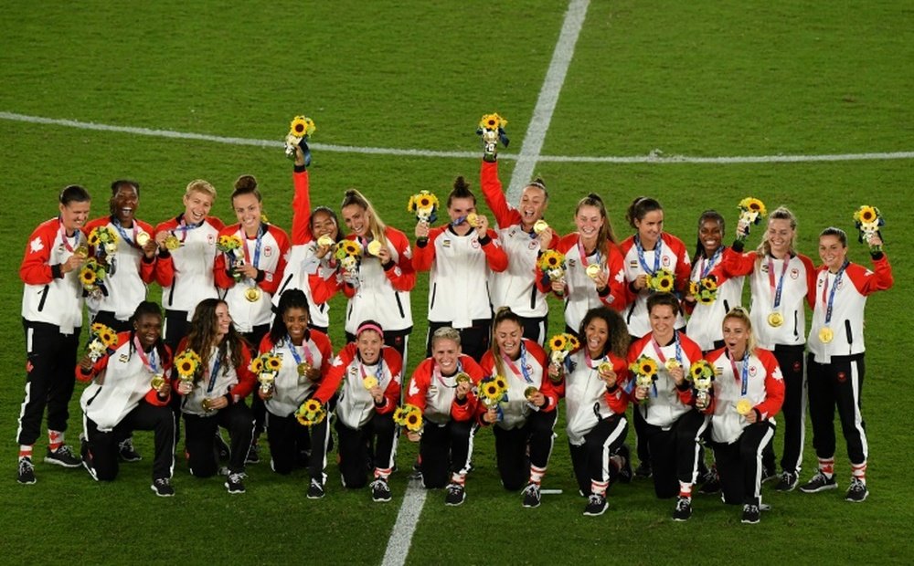 Canada pose with their Olympic gold medals after beating Sweden on penalties. AFP