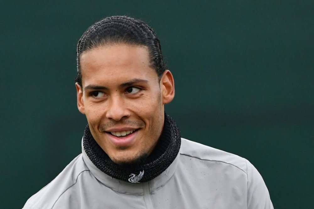 Van Dijk fears Liverpool will win title in empty stadium. AFP