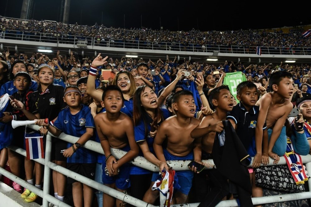Local fans celebrate after Thailand won the AFF Suzuki Cup Final against Indonesia. AFP