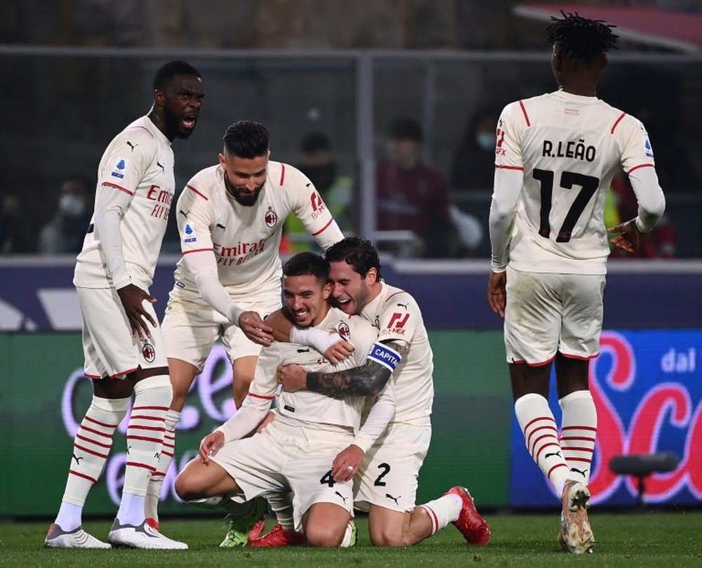 Milan beat nine-man Bologna to move top of Serie A. AFP
