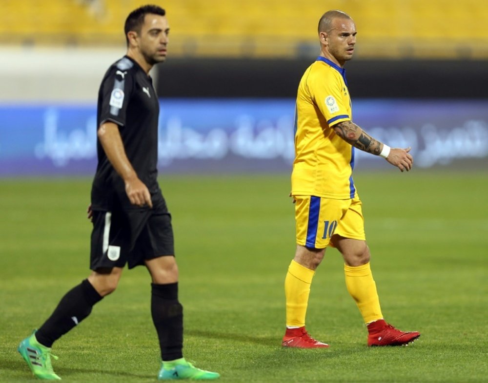 Xavi beats Sneijder - this time in Qatar. AFP