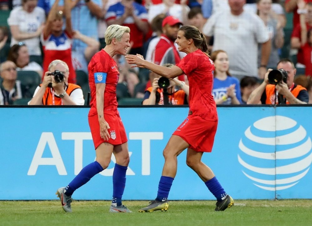 Megan Rapinoe (L) will not be at the NWSL tournament in Utah due to COVID-19 concerns. AFP
