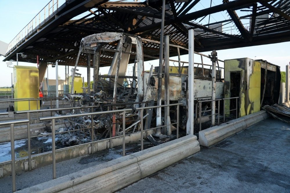 The clash at a motorway toll gate left a supporters coach burnt out. AFP