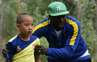 Under the watchful eye of Daniel Tagoe, a coach from Ghana, around 30 children wearing blue and yellow kits learn to play football in a village outside the Kyrgyz capital Bishkek.