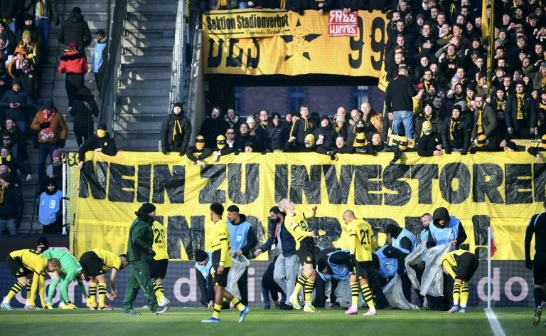 Dortmund fans unveil a banner opposing investment in German football. AFP