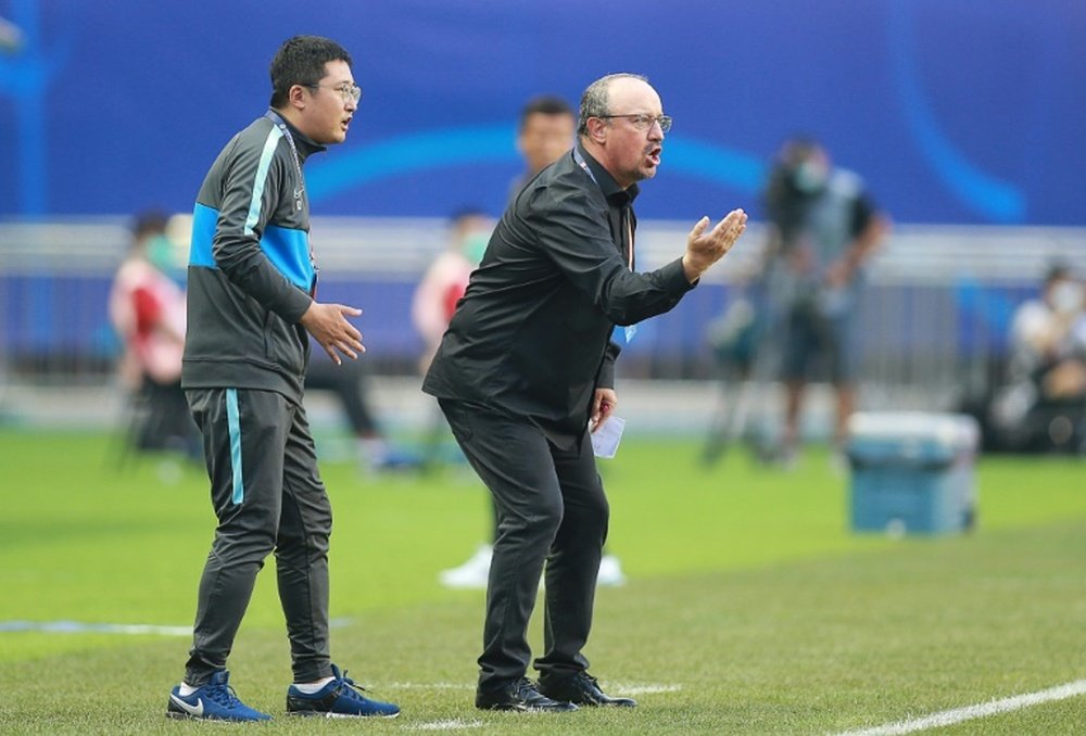 Benitez, van Bronckhorst plunged into China basement scrap. AFP