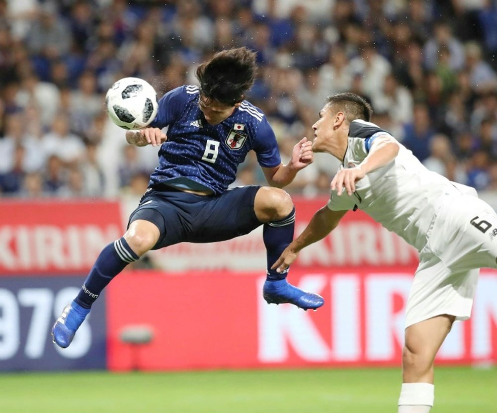 Japan's midfielder Takumi Minamino pictured scoring for Japan. AFP