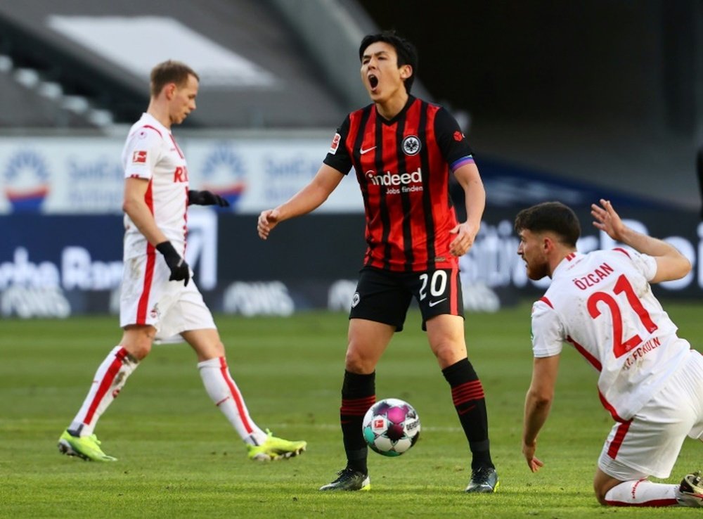 Makoto Hasebe, 37, (C) has renewed his contract until summer 2022. AFP