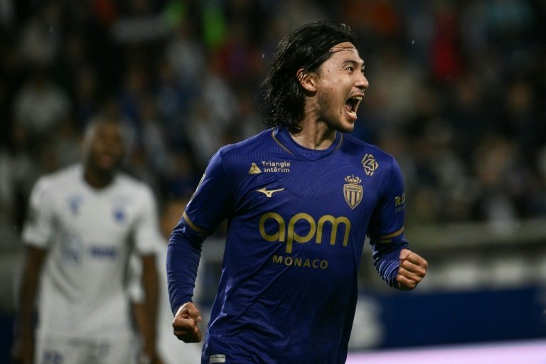 Monaco squeeze past 10-man Auxerre to climb to third. AFP