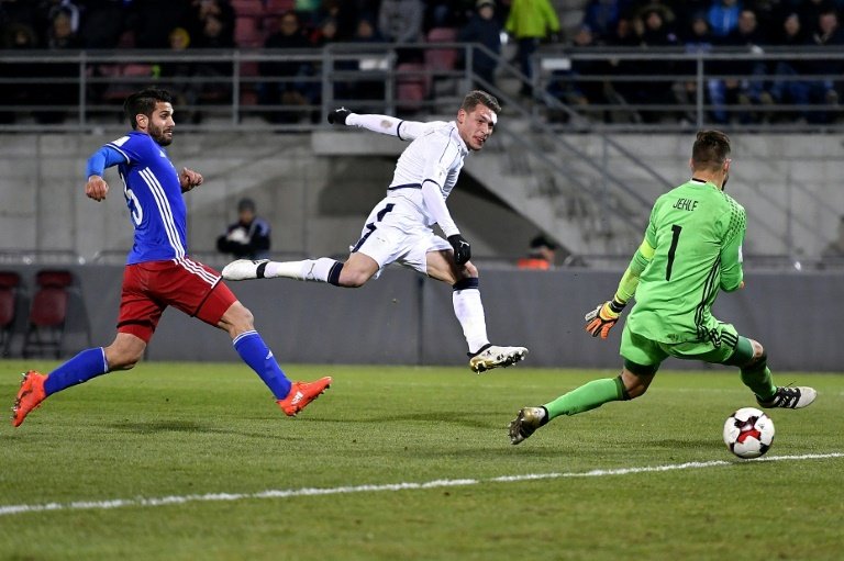 Italys forward Andrea Belotti (C) scores past Liechtensteins defender Michele Polverino (L) and goalkeeper Peter Jehle on November 12, 2016