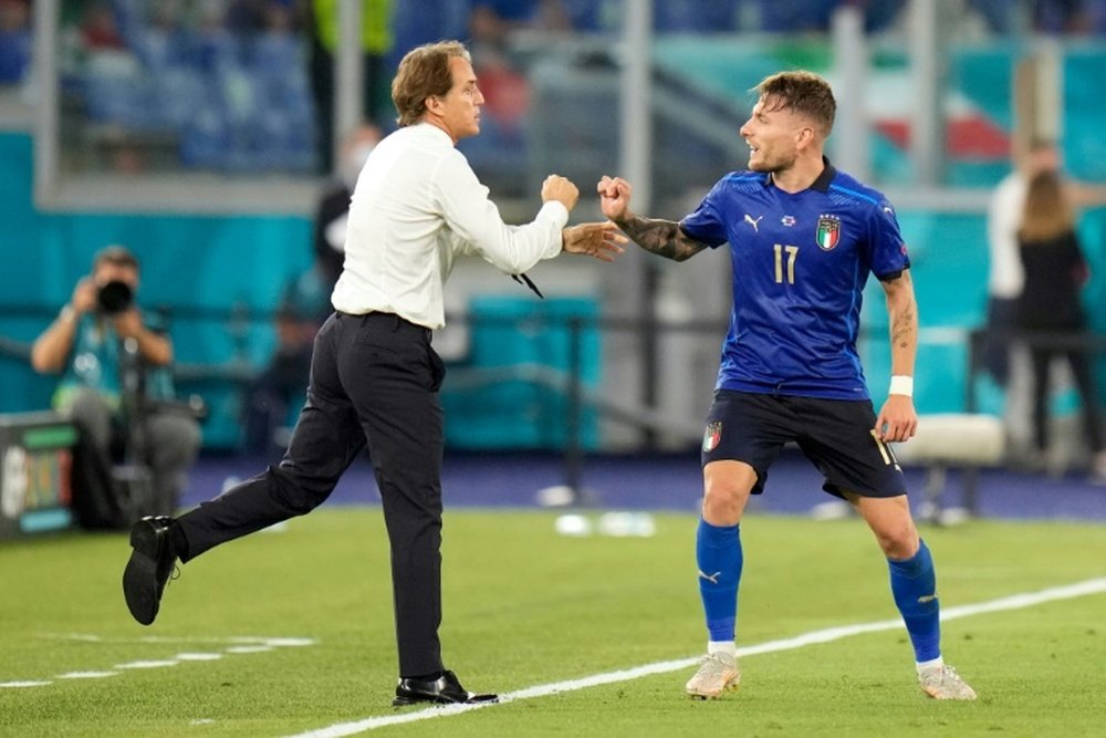Roberto Mancini (L) praised his team after victory v Switzerland. AFP
